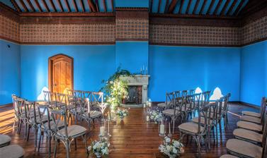 Chairs arranged in the Westwood room for a ceremony centering on the fireplace