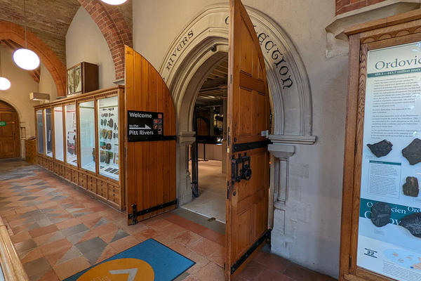 The entrance to the Pitt Rivers Museum is two large wooden doors under an arch