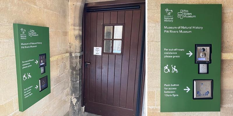 Green sign beside a wooden door at the Oxford University Museum of Natural History showing an intercom and push-button for accessible entry, with wheelchair and stroller symbols.