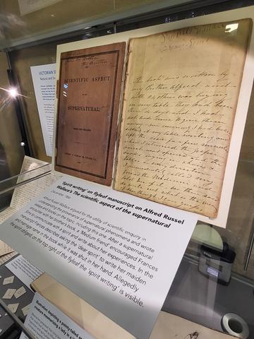 Archival letter on display in glass case with accompanying label