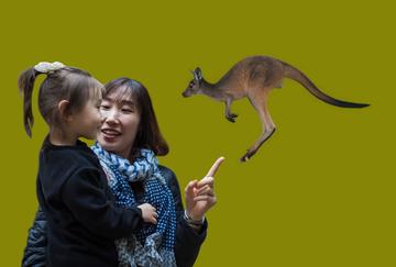 A mother and daughter looking at a kangaroo