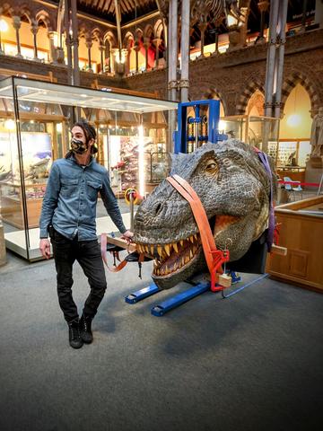 Ben standing in front of the T Rex head at the Museum