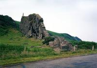Photography of an outcropping of rock on grassy hill