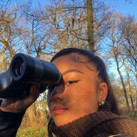 Lira Valencia looking through binoculars